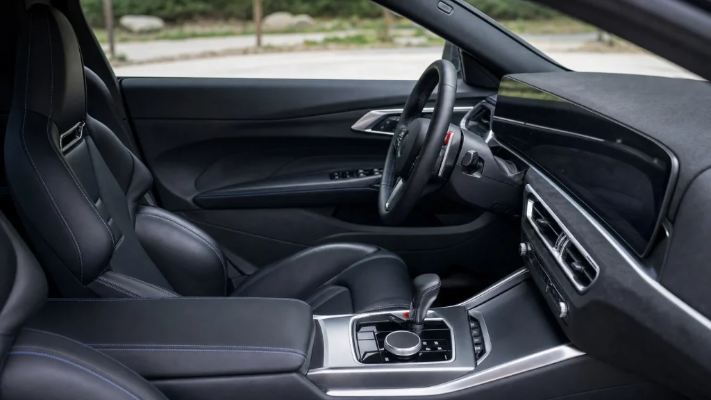 The Curved Display and sport seats inside a 2023 BMW M2.