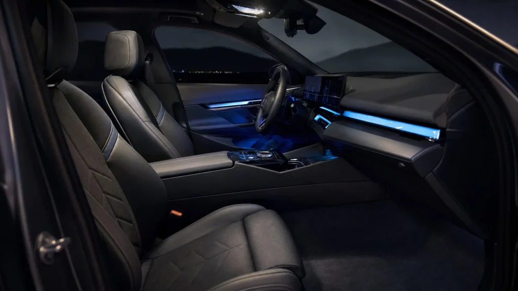 The premium leather interior and dashboard of a 2023 BMW M5.