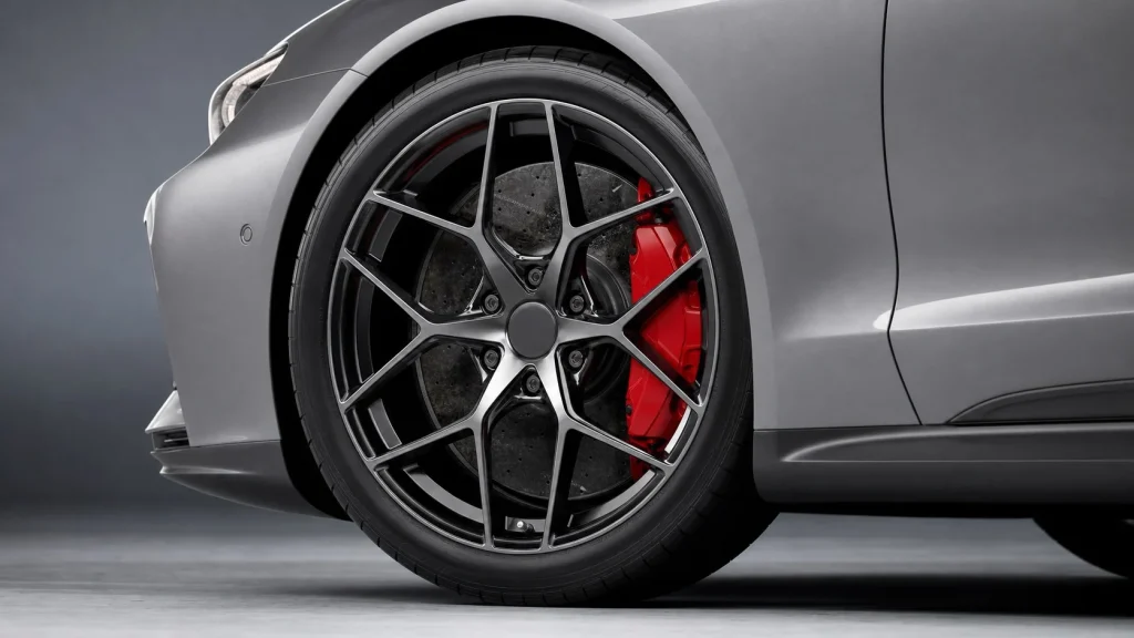 Detailed view of the multi-spoke wheel and red brake calipers of a 2024 Audi e-tron GT.