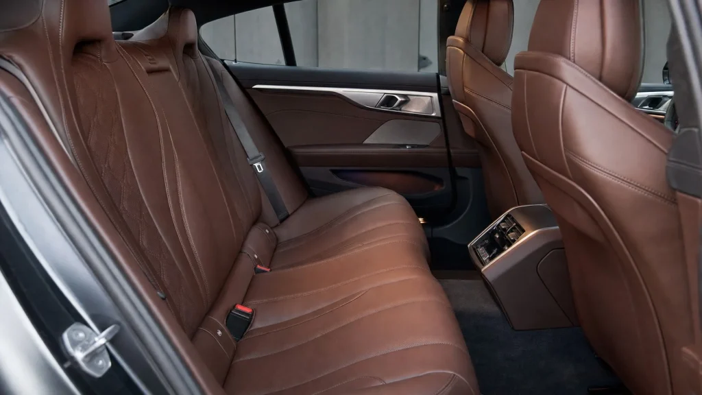 2024 BMW 8 Series Gran Coupe Specs, MSRP Pricing & Review 2 Detailed view of the premium Merino leather rear passenger seats and legroom in the 2024 BMW 8-Series Gran Coupe.