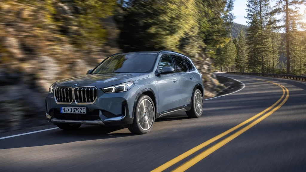 A 2024 BMW X1 xDrive28i handling a sharp turn on a scenic mountain road
