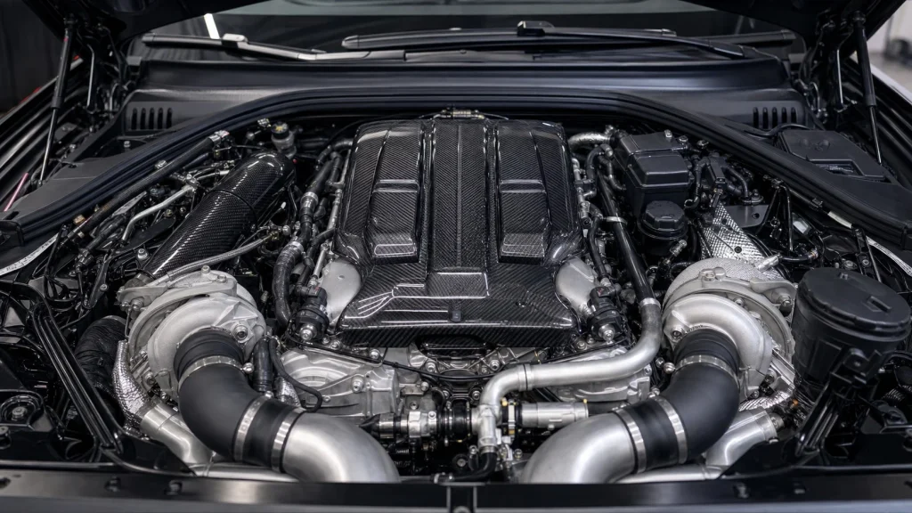 A close-up view of the BMW S58 twin-turbocharged inline-six engine under the hood.