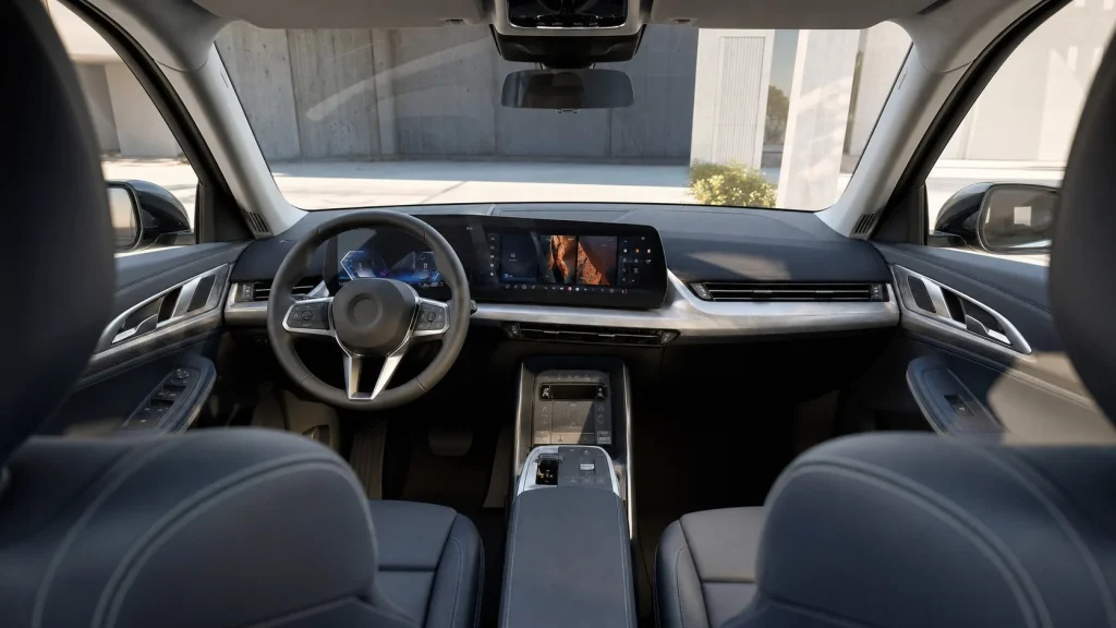 The high-tech interior dashboard of a luxury subcompact crossover featuring a glass Curved Display.