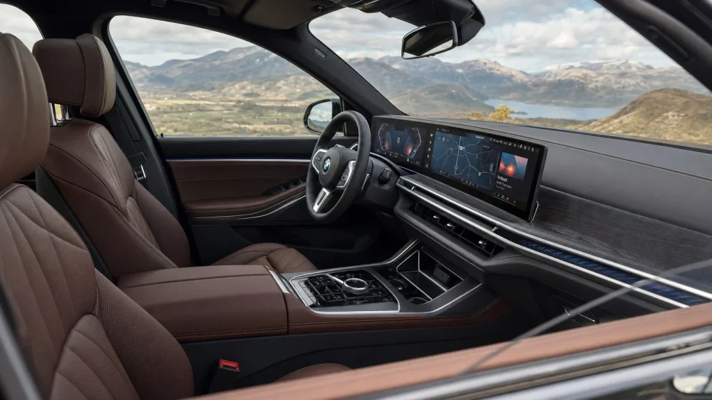 Interior dashboard and front seat cabin view of a BMW X5 illustrating passenger legroom and headroom.